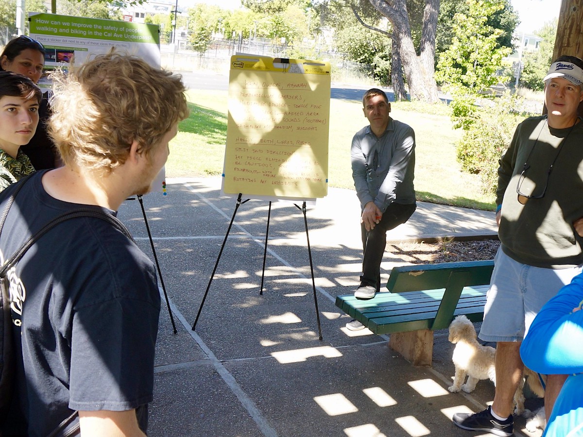 People discussing the recurring themes amongst all of the models of the California Avenue underpass that were built.