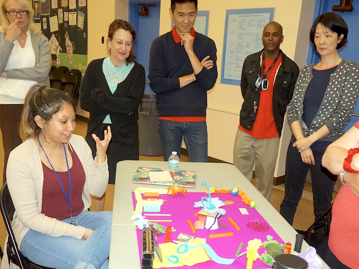 A teacher talking about her model for a redesigned parking lot.